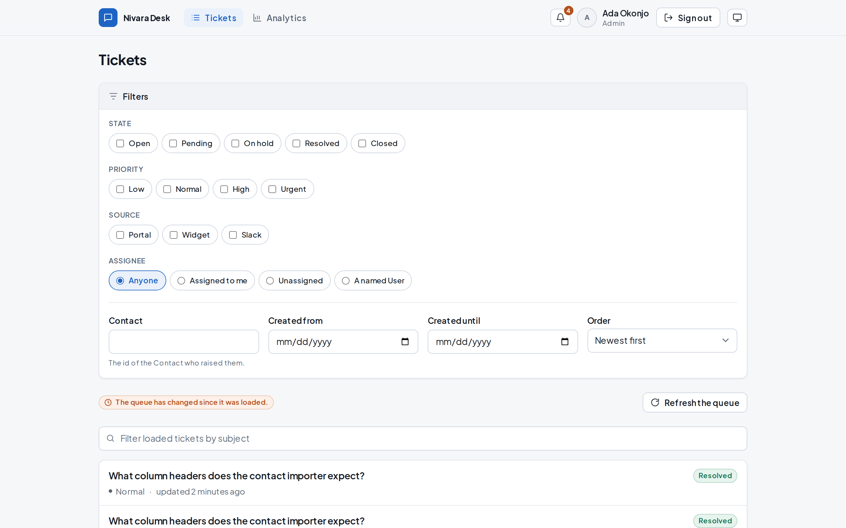 A ticket queue with filters for state, priority, source and assignee, listing tickets newest first, ending in a load-more control rather than page numbers.